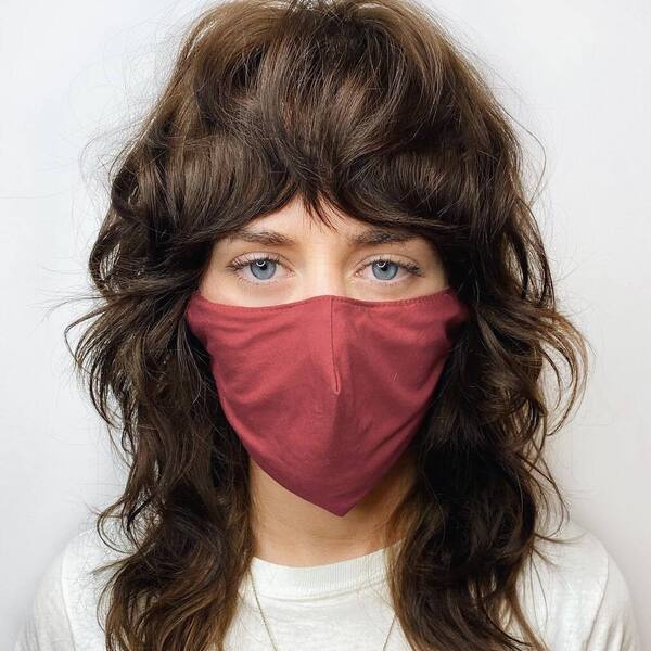 Rock Star Shaggy Hairstyle- a woman wearing a red face mask and a white t-shirt