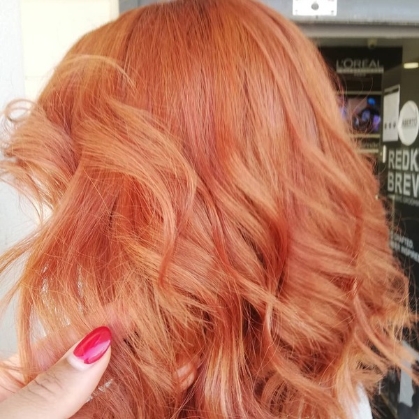 Rose-Gold Fall Hair Colors- a woman wearing a white sweater