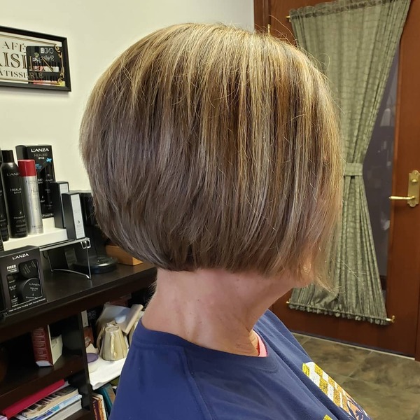 Round Bob Hairstyles for Women Over 60- a woman over 60 wearing a dark blue t-shirt