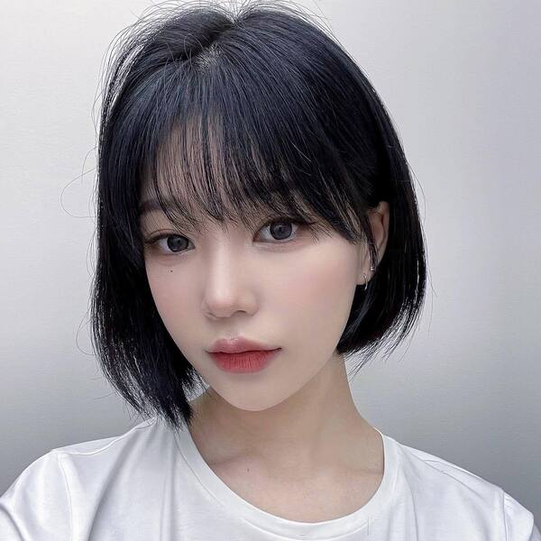 Round Bob- an Asian woman wearing a white t-shirt