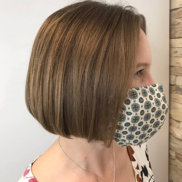 Rounded Bob 90's Hairstyles- a woman wearing a face mask