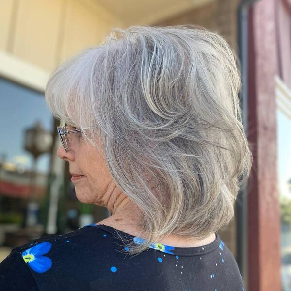 Salt and Pepper for Short Hair- a woman over 60 wearing a black floral patch blouse