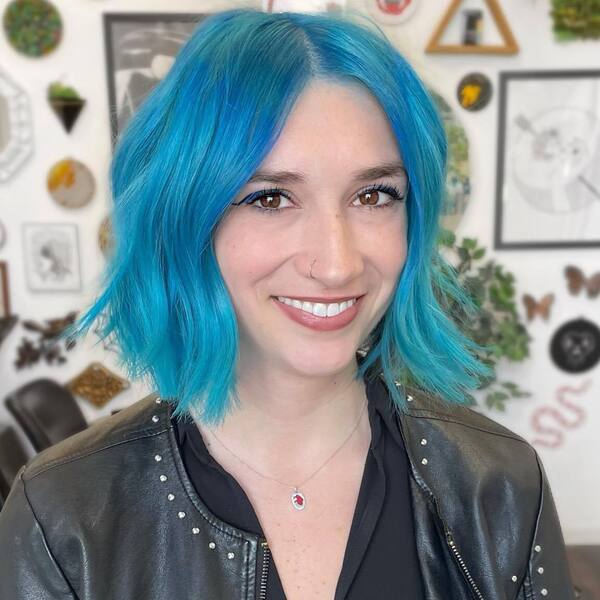Sea Blue Hair Color for Hazel Eyes- a woman with hazel eyes wearing a black leather jacket