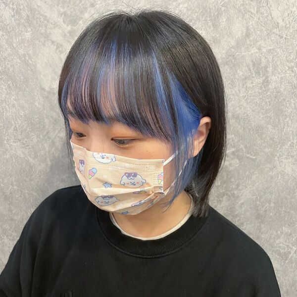 Shaped Long Bob with Blue Highlights- an Asian woman wearing a face mask and a black t-shirt