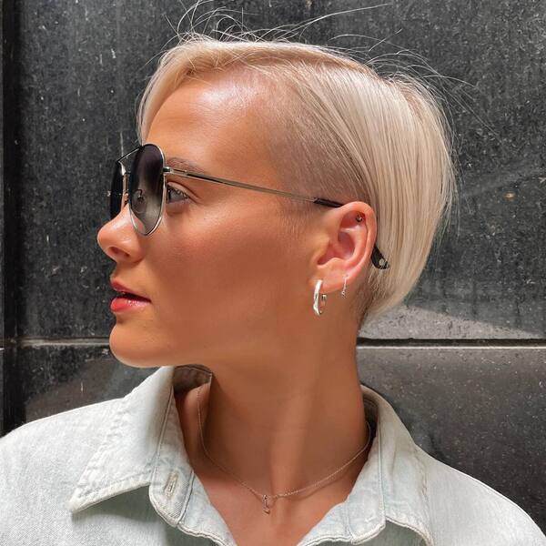 Short Blonde Pixie Cut- a woman wearing a sun-glass
