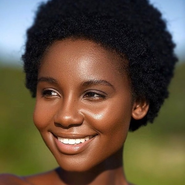 Short Fluff Hairstyle for Black Women- a black woman smiling