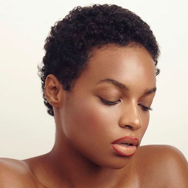 Short Natural Curly Hairstyle for Black Women- a black woman wearing a red lipstick