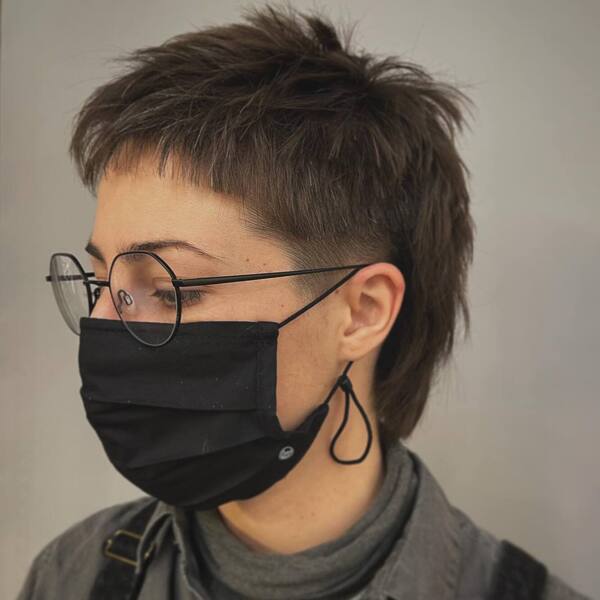 Short Shaggy Pixie Haircuts- a woman wearing a black face mask