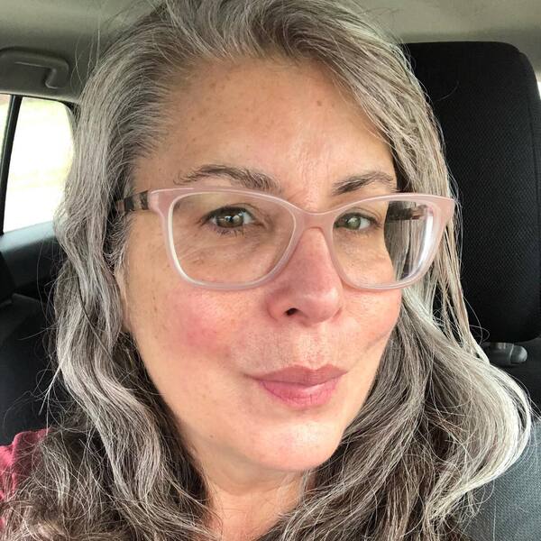 Shoulder-Length Hairstyles for Women with Gray Hair and Blonde Highlights- a woman over 60 wearing an eyeglasses