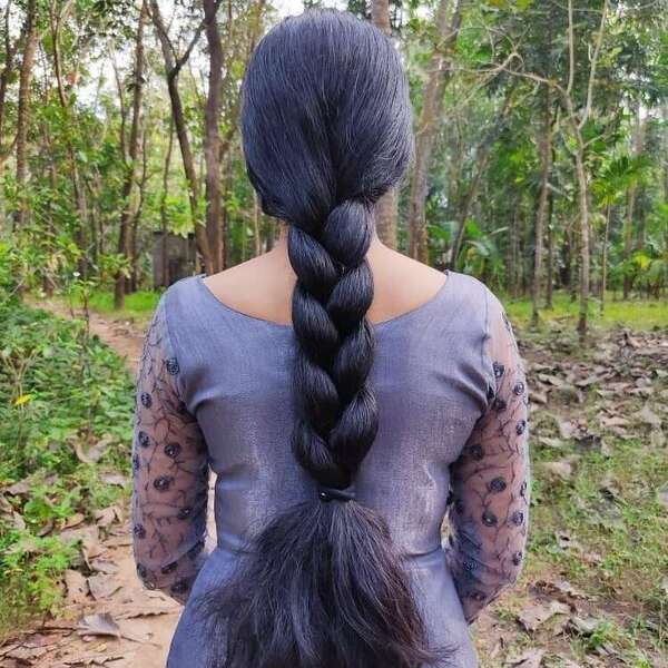 Simple Braid for Long Thick Hair- a woman wearing a black blouse