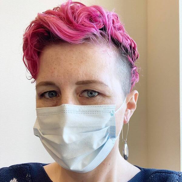Skin Fade Cut with Pink Top- a woman wearing a face mask