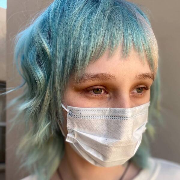 Soft Blue- a woman wearing a white face mask