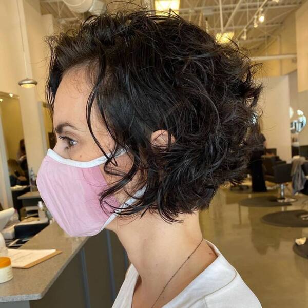 Soft Curls Pixie- a woman wearing a pink face mask