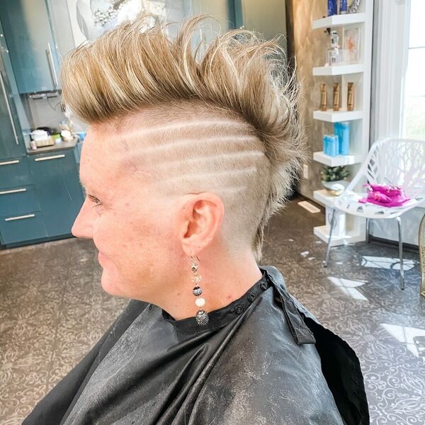 Spiky Shaved Hairstyles for Woman- a woman wearing a black barber's cape