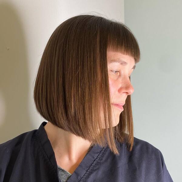 Straight Bangs - a woman in a side view