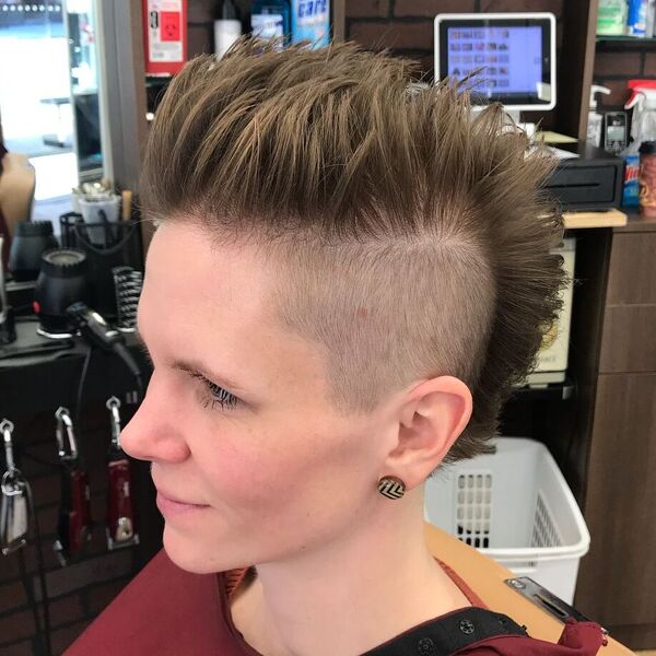 Straight Up Mohawk- a woman wearing a red barber's cape