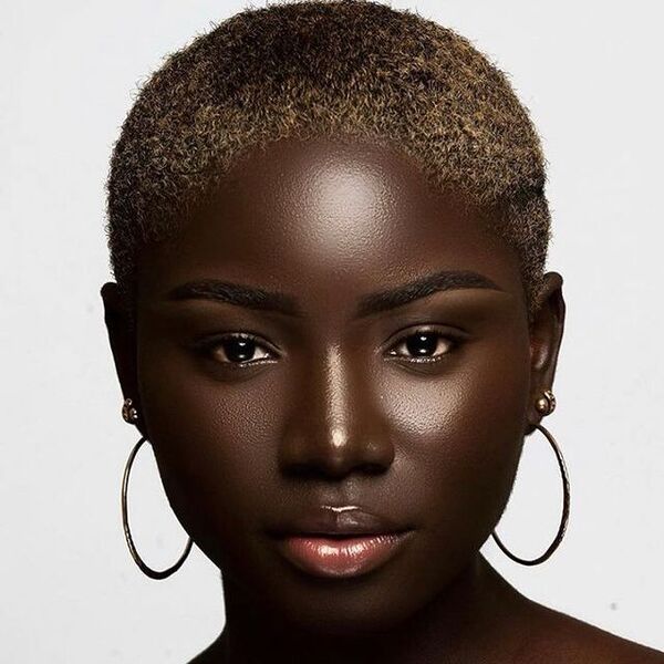 Tall Top Haircuts for Black Women- a black woman wearing a big earrings