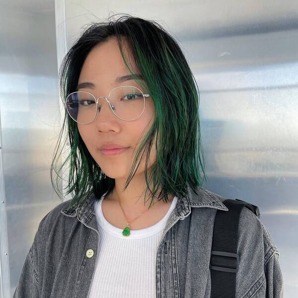 Textured Bob with Green Ombre- a woman wearing a gray denim jacket