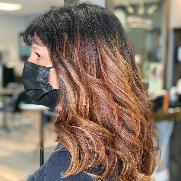 The Classic Ombre Hairstyle- a woman over 60 wearing a black face mask