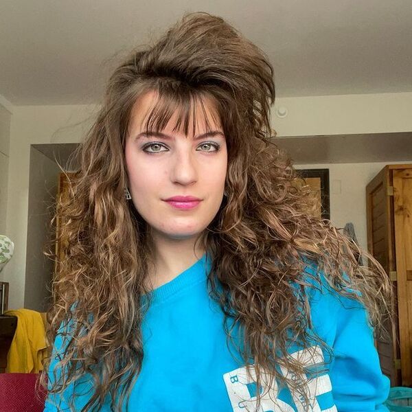 The Poof Hairstyle- a woman wearing a blue t-shirt