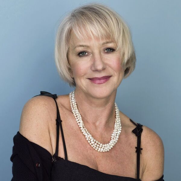 The Queen of Hairstyles- Helen Mirren wearing a black off-shoulder dress with necklace