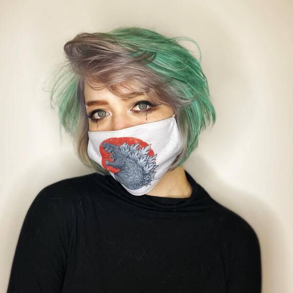 The Rival Inspired Hairstyle- a woman wearing a face mask and a black sweater