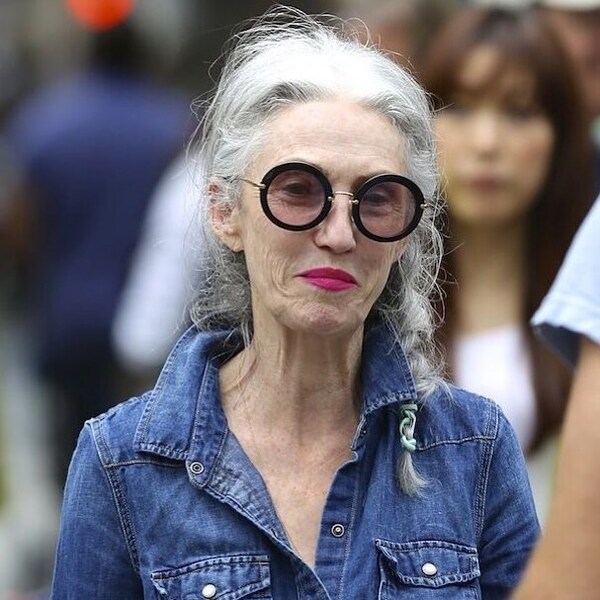 The Silver Mane Hairstyle- a woman over 60 wearing a denim jacket