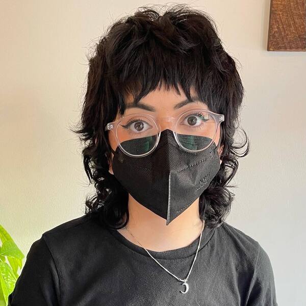 The Ultimate Face-framing Bangs- a woman wearing a black face mask
