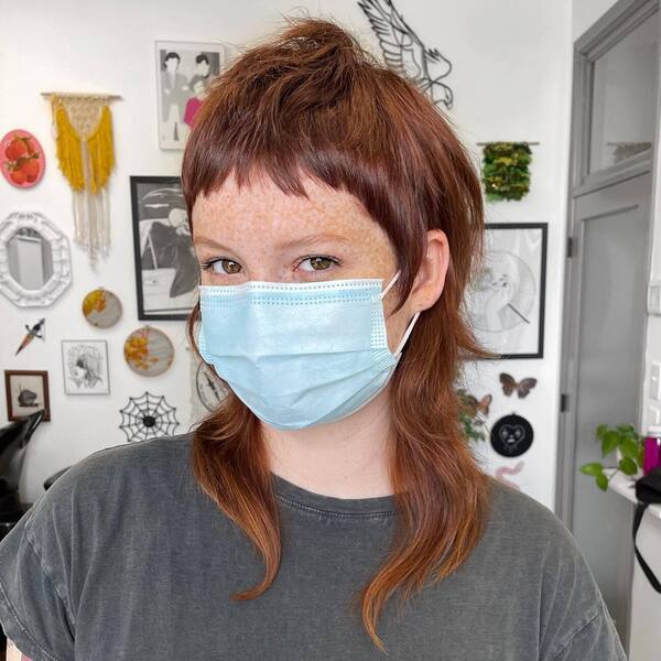 Tiny Bangs Hairstyles- a woman wearing a face mask and a gray t-shirt