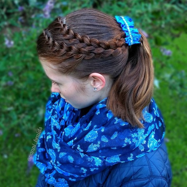 Tiny French Braids- a woman wearing a blue scarf and a blue jacket