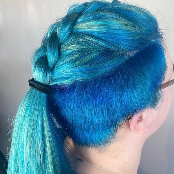 Top Braids Ponytail Blue Hairstyle- a woman wearing an eyeglass