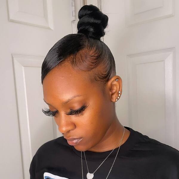 Top Knot Hairstyle- a woman wearing a black t-shirt