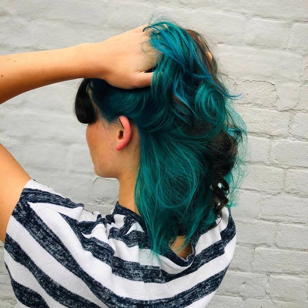 Turquoise Highlights for Edgy Hairstyles- a woman wearing a black and white stripes t-shirt