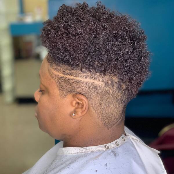 Undercuts Natural Short Haircuts For Black Women-a black woman wearing a white barber's cape