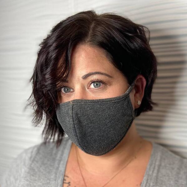Uneven Pixie Cut- a woman wearing a gray face mask