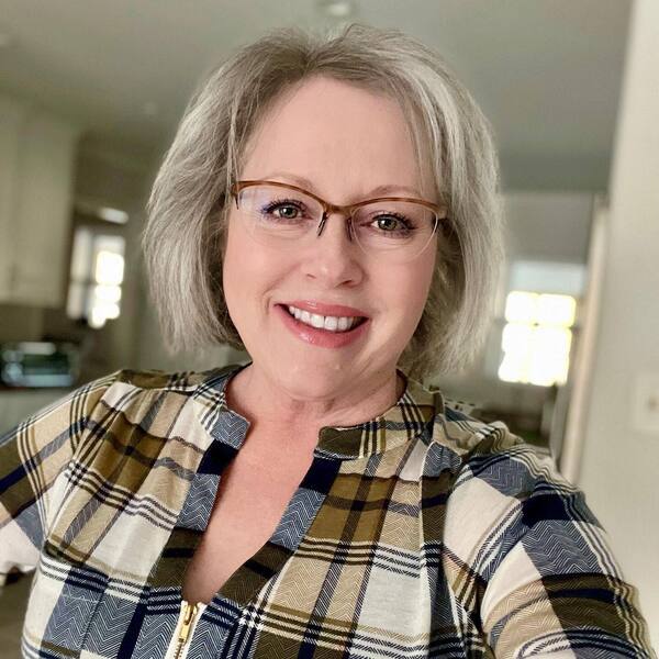 Variations in Education- a woman over 60 wearing a checkered blouse
