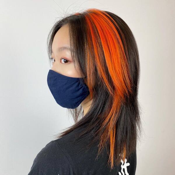Villain Inspired Hairstyle- a woman wearing a dark blue face mask