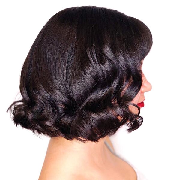 Vintage Curls Bob Hairstyle for Thick Brown Hair- a woman wearing a white camisole dress