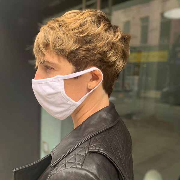 Wavy Pixie Haircut for Thick Hair- a woman wearing a white face mask and a black leather jacket