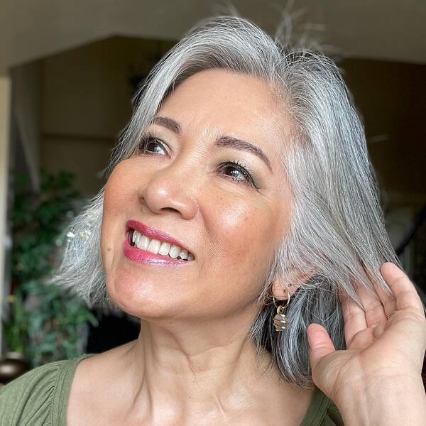 White Halo- a woman with gray hair wearing a green blouse