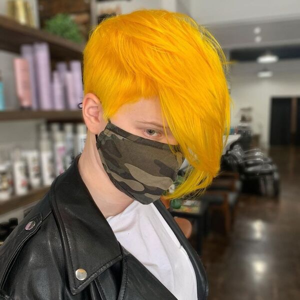 Yellow Long Bangs Colorful Hairstyle Ideas- a woman wearing a face mask and a black leather jacket