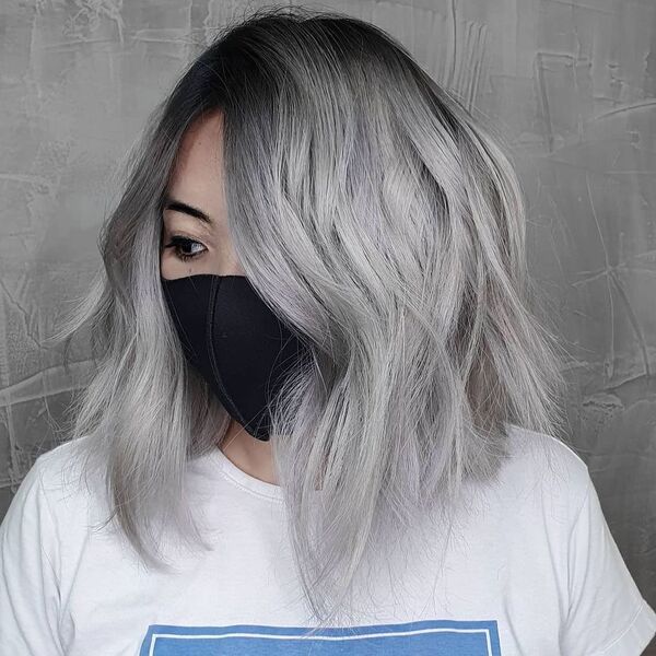 Black to White Hair Color- a woman wearing a black face mask