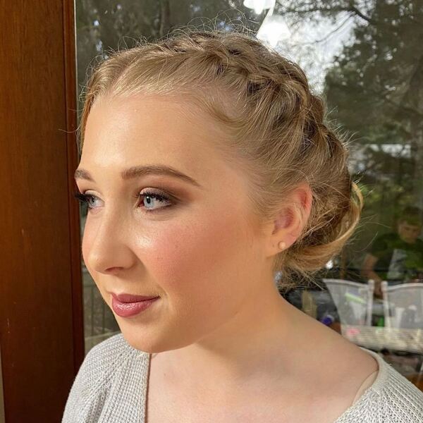 Braided Buns for Round Faces- a woman wearing a white sweater dress