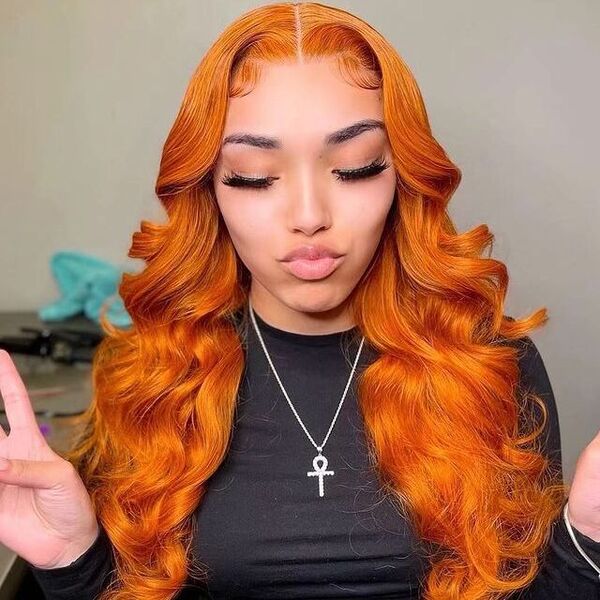 Bright Orange Layered Hairstyles for Long Hair - a woman wearing a black long sleeves