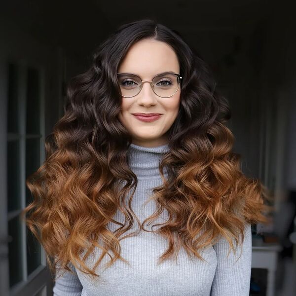 Extra Volume Layered Hairstyles - a woman wearing a winter suit