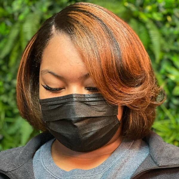 Fall Colors Haircuts for Round Faces- a woman wearing a black face mask