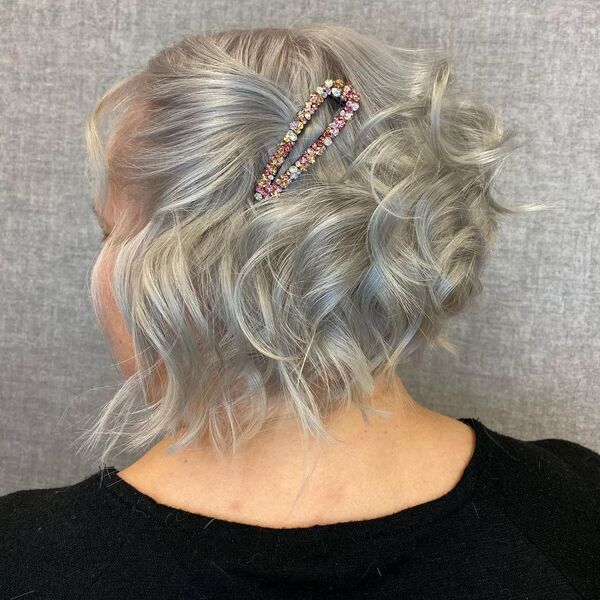 Messy Updo for Gray Hair Color- a woman wearing a black t-shirt