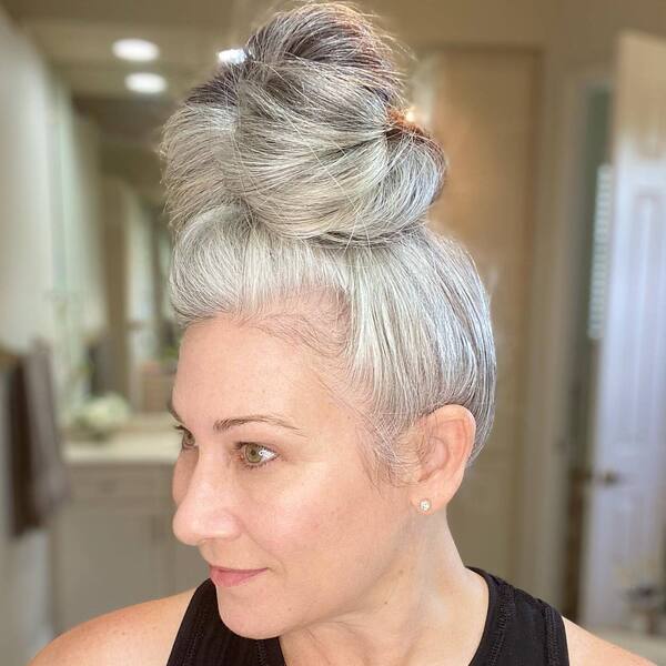 Natural Gray Hair with Top Bun- a woman wearing a black tank top