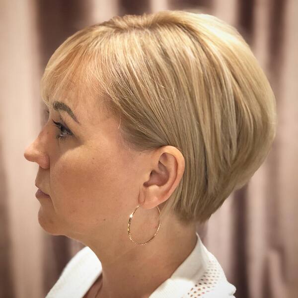 Natural Haircuts for Round Faces- a woman wearing a white dress