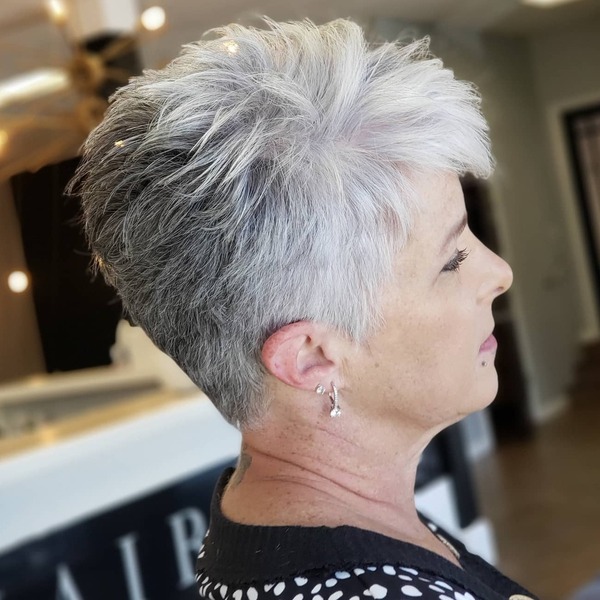 Pixie Cut with Gray Hair Color- a woman wearing a black dress